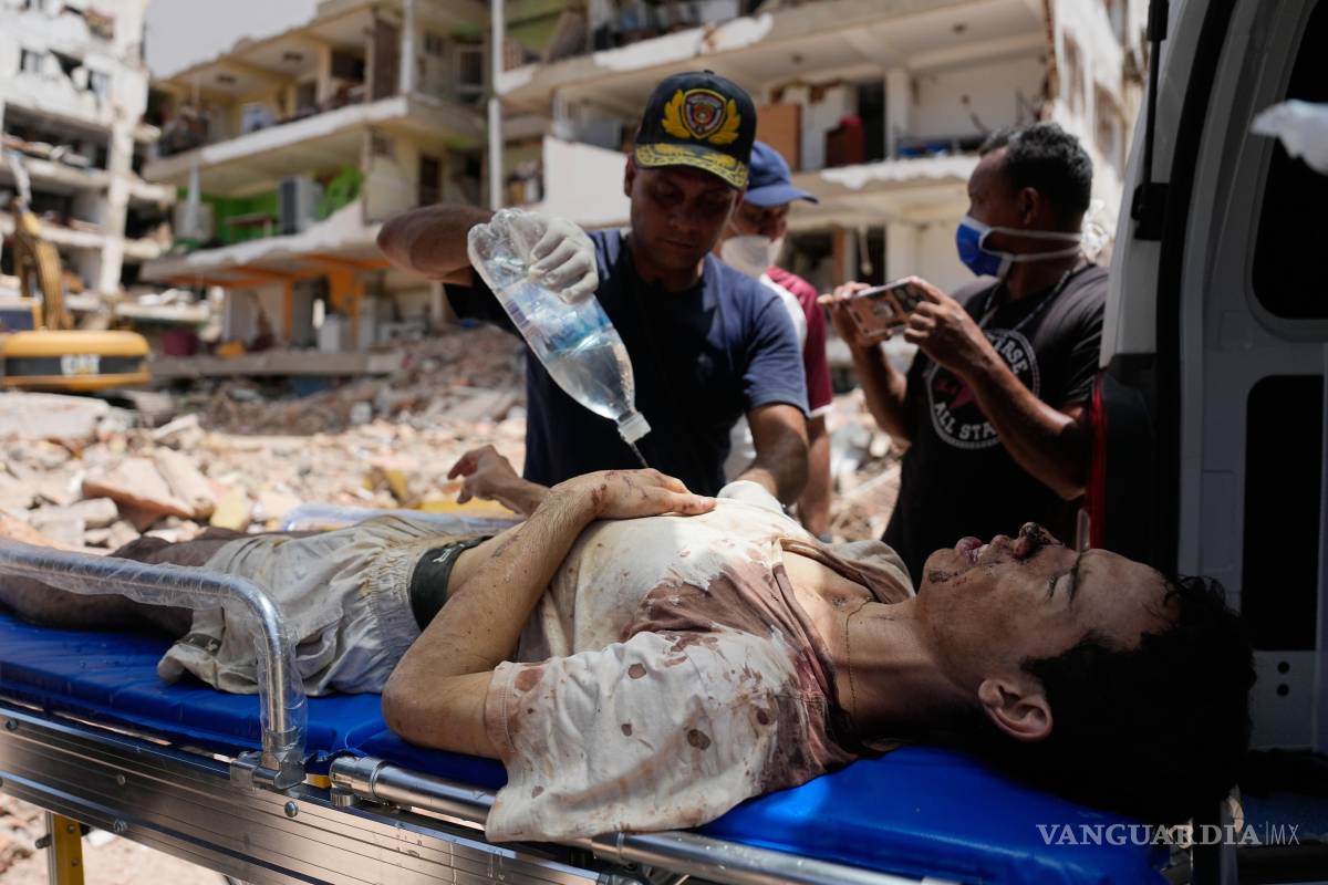 $!Los rescatistas suben a Daniel Cordero a una ambulancia tras sacarlo de entre los escombros de su casa dos días después del terremoto que azotó Catia La Mar.