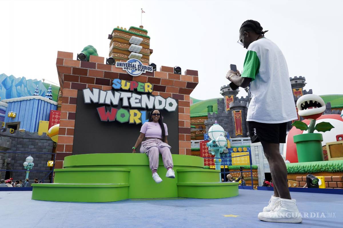 $!Charles Brockman, right, of Austin, TX, takes a picture of Melissa Baker in the main plaza of the new Universal Studios Hollywood attraction Super Nintendo World during a preview day, Thursday, Feb. 16, 2023, in Universal City, Calif. The attraction opens to the public Friday. (AP Photo/Chris Pizzello)