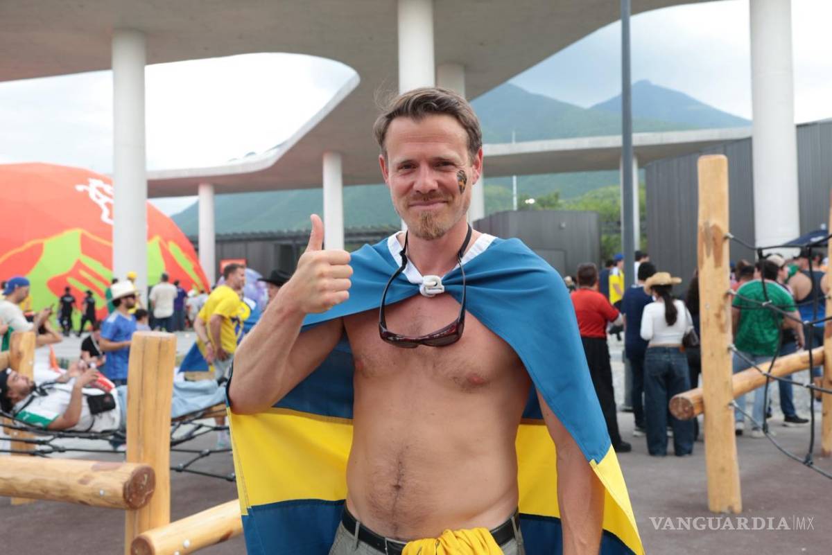 $!Hampus, aficionado sueco, desafía el calor regio de 30 grados mientras recorre el Parque del Agua con la bandera de su país como capa.
