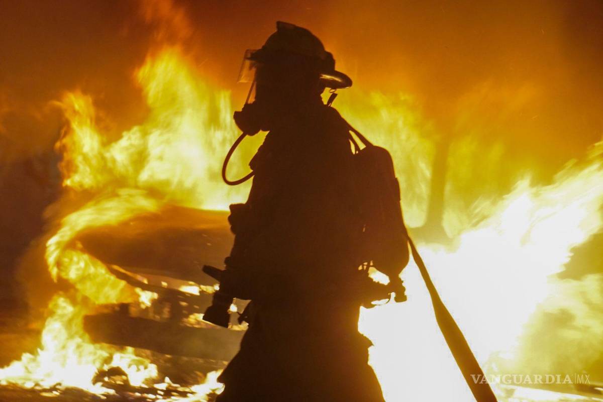 $!Bomberos sofocan las llamas de un vehículo incendiado en el centro de la ciudad.