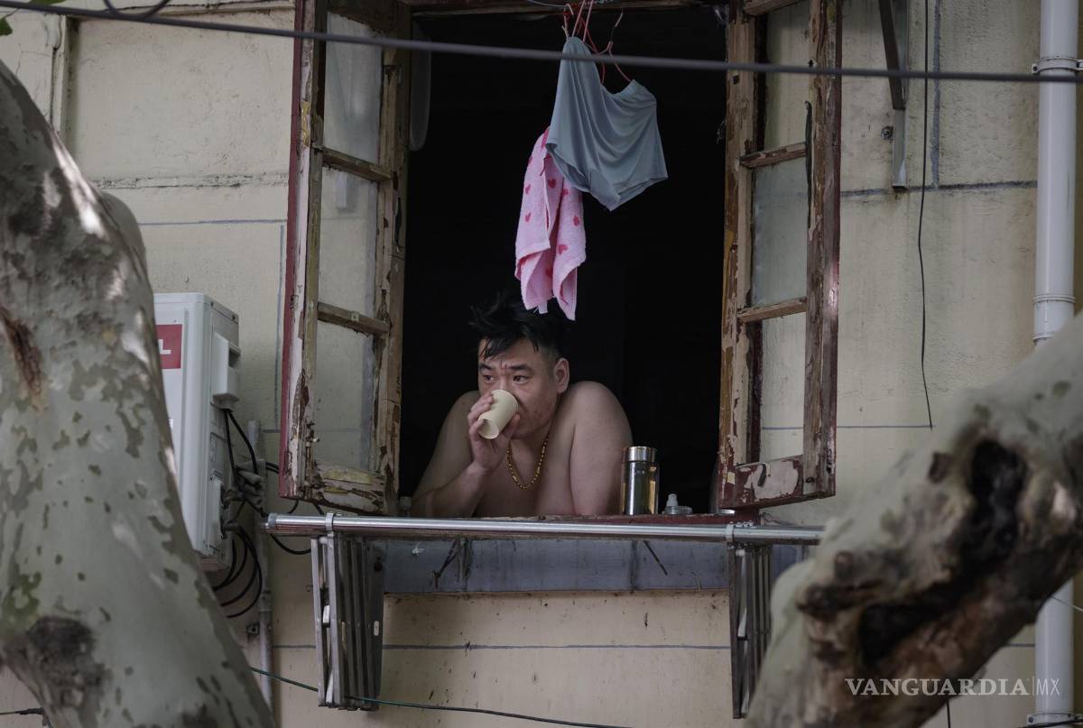 $!A man stands at his window prior to a lockdown lifting in Shanghai, China.