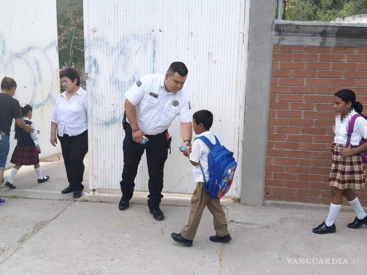 $!Agentes de seguridad interactúan con los estudiantes en la entrada de una escuela.