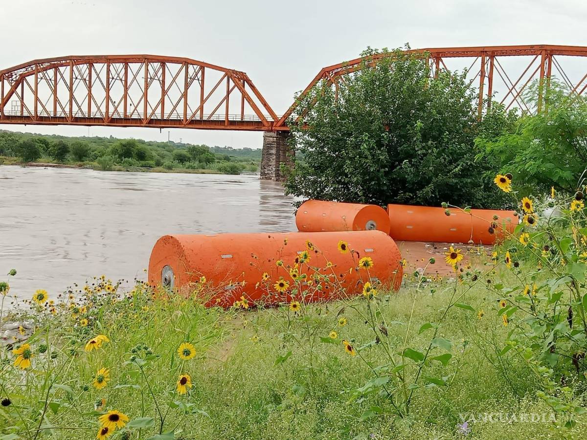 $!Las boyas de la barrera flotante permanecían en la margen del Río Bravo, mientras continuaban las labores de vigilancia por el incremento del nivel del agua.