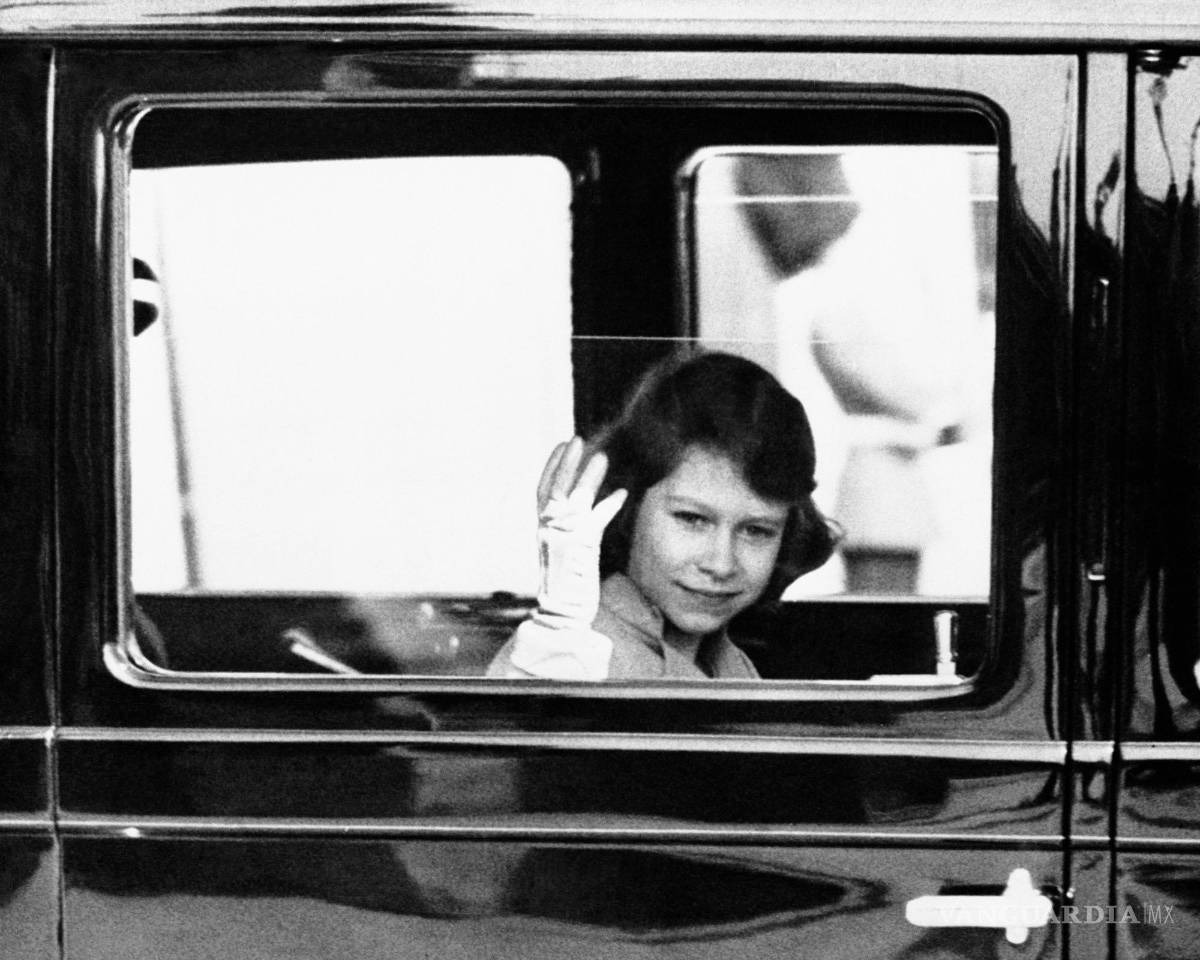 $!Imagen del 6 de junio de 1937, la princesa Isabel de Gran Bretaña, aspirante al trono, saluda a la multitud que la vio salir del Palacio de Buckingham en Londres.