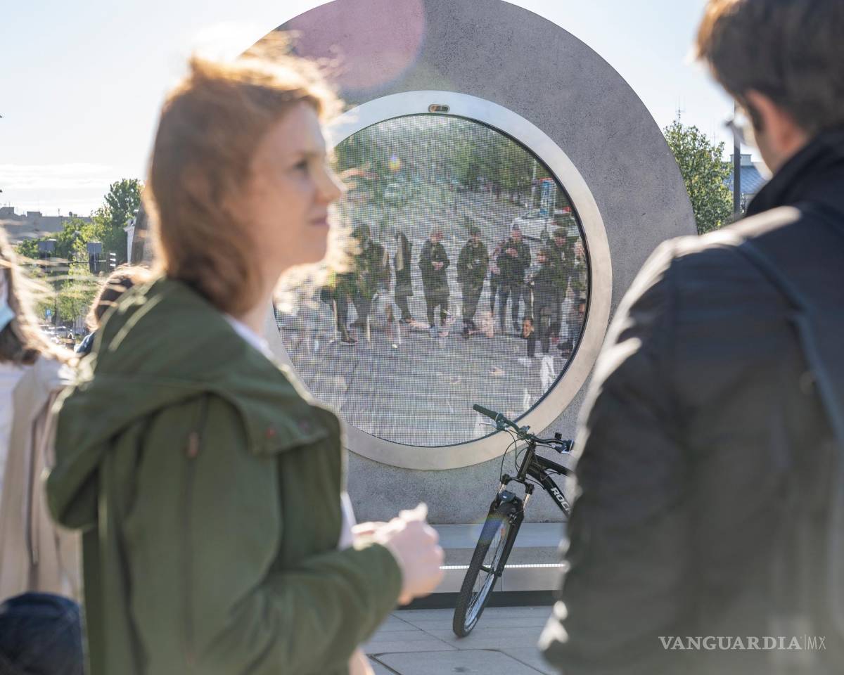 $!Una pareja se detiene ante el terminal de 'pOrtal' en Vilna, Lituania y observa a otro grupo de jóvenes polacos del otro lado de este portal casi dimensional. EFE/Benediktas Gylys Foundation/Vilnius Gediminas Technical University
