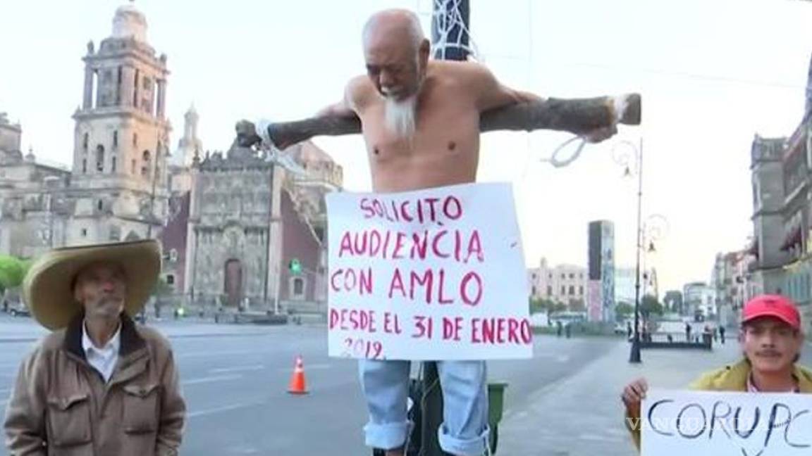 Hombre se crucifica afuera del Palacio Nacional y exige que AMLO lo atienda