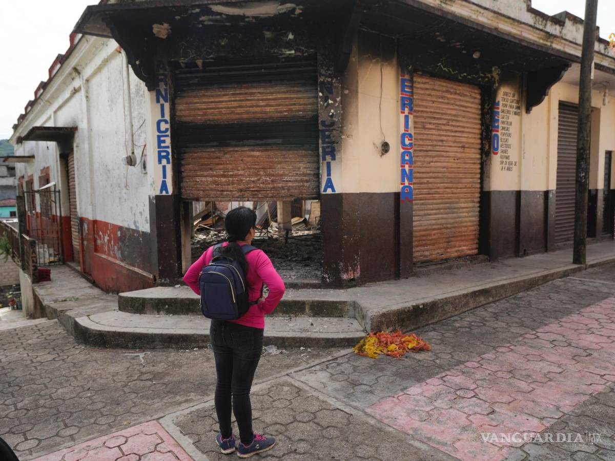 $!Una vecina observa los restos quemados de un edificio incendiado en Tila, en el estado de Chiapas, México.