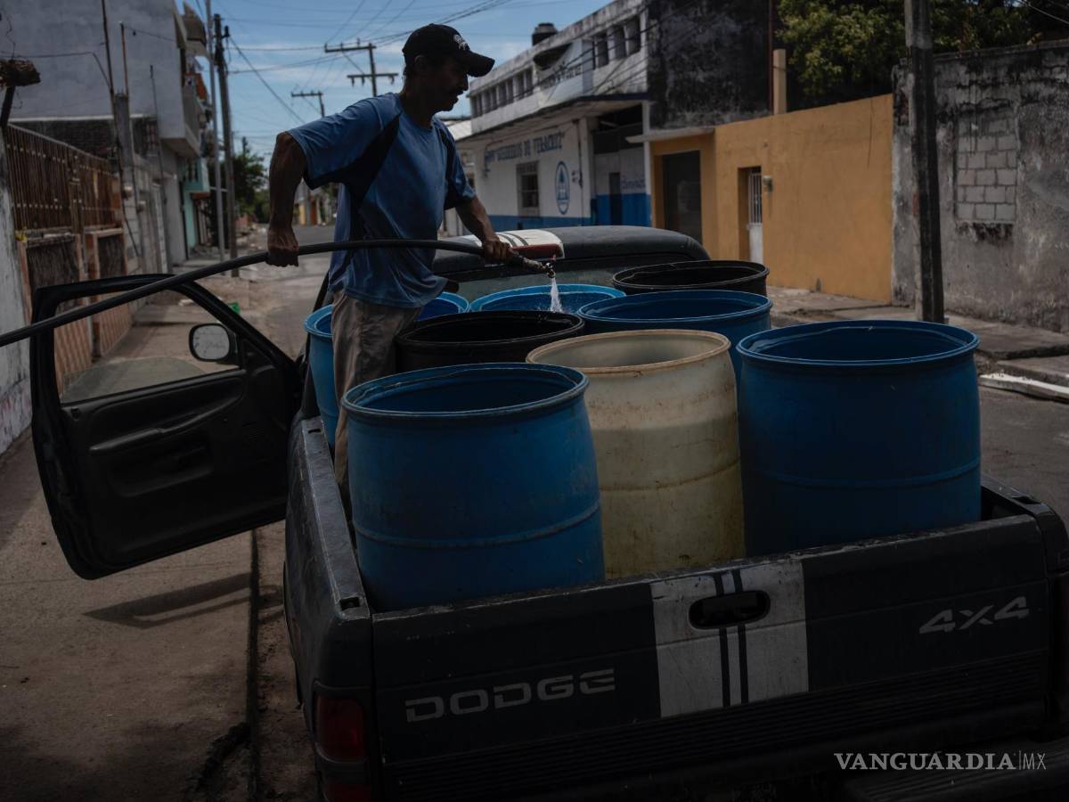 $!Un hombre llena bidones con agua debido a la escasez causada por las altas temperaturas y la sequía en Veracruz, México.