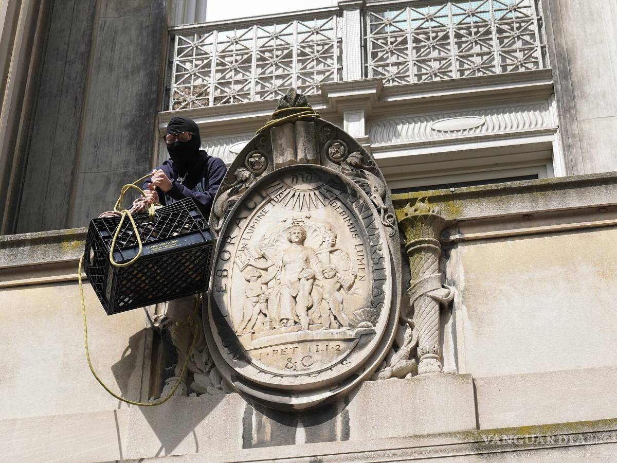 $!Un estudiante manifestante saca una caja llena de alimentos y suministros desde un balcón de Hamilton Hall en el campus de la Universidad de Columbia.