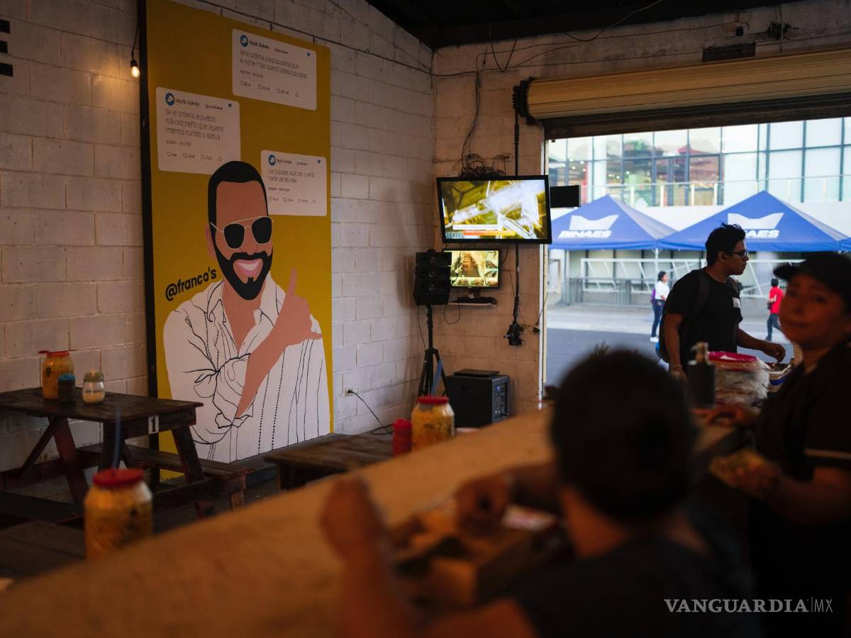 $!Clientes en una tienda de alimentos decorada con un mural del presidente de El Salvador, Nayib Bukele en el centro de San Salvador, El Salvador.