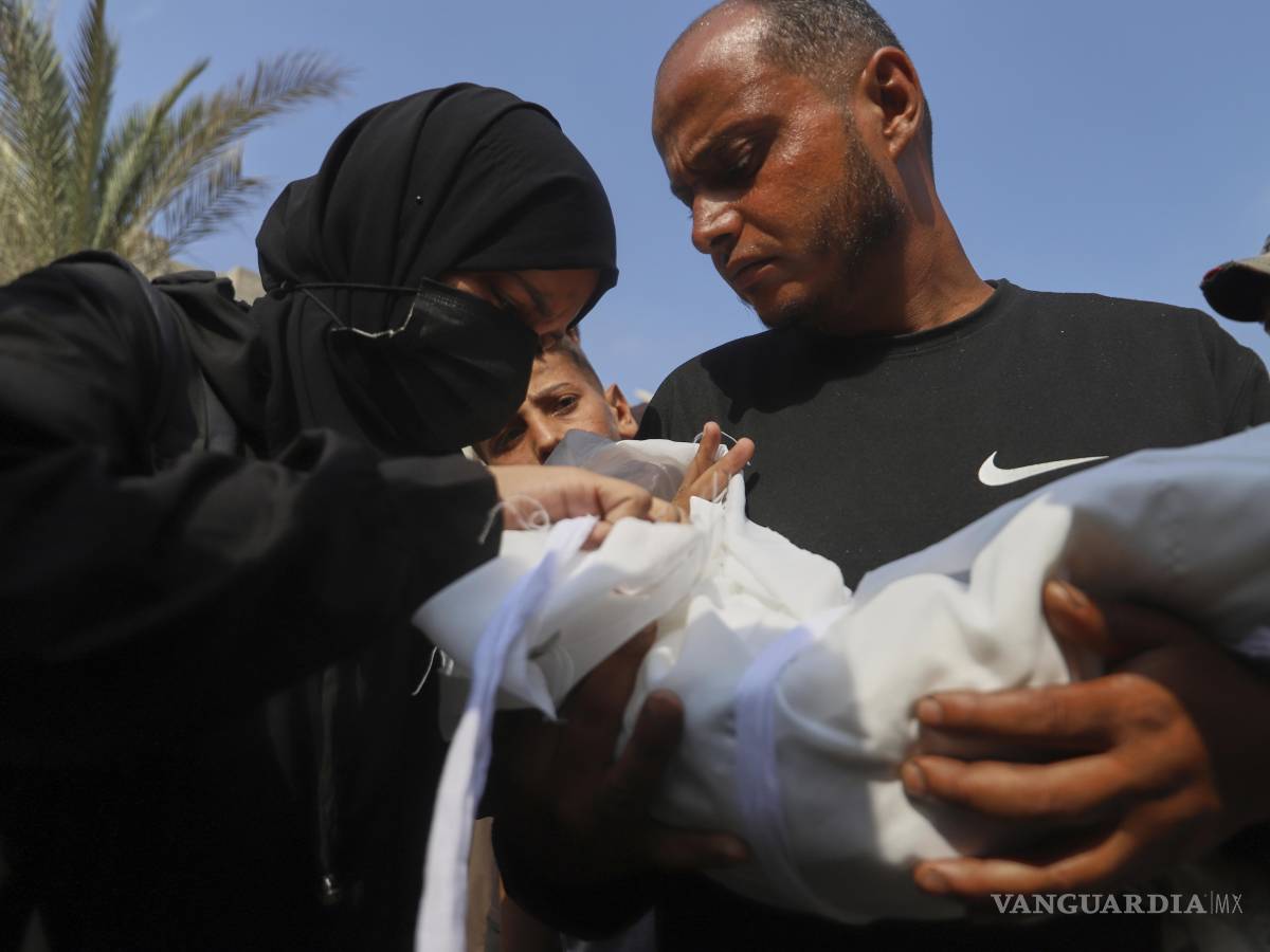 $!Ahmed Abu Halib y su esposa Esraa Abu Halib lloran sobre el cadáver de su bebé de cinco meses de edad, Zainab, que murió a causa de desnutrición, en Jan Yunis.