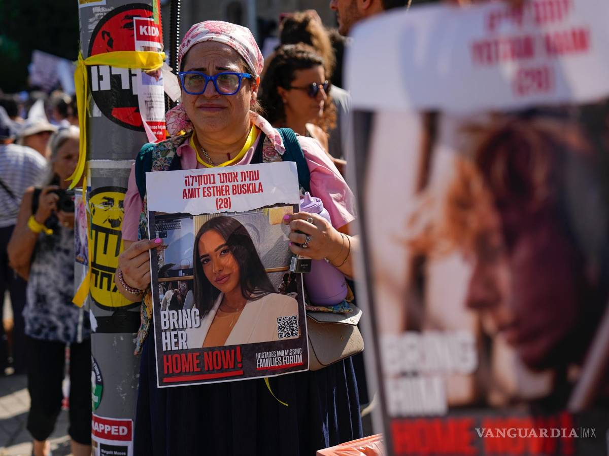 $!Residentes del kibutz Kfar Azza atacada por Hamás, sostienen fotografías de sus seres queridos, piden el regreso de más de 220 rehenes, en Tel Aviv, Israel.