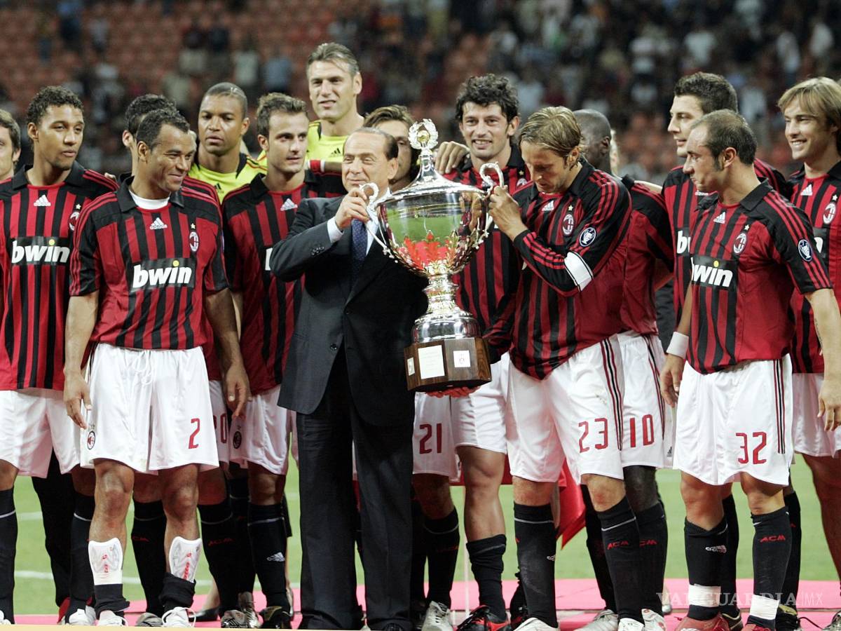 $!FILE - AC Milan president Silvio Berlusconi, center in dark suit, celebrates with the team after defeating Juventus to win the Luigi Berlusconi Trophy exhibition soccer match at the San Siro stadium in Milan, Italy, on Aug. 17, 2007. Berlusconi, the boastful billionaire media mogul who was Italy's longest-serving premier despite scandals over his sex-fueled parties and allegations of corruption, died, according to Italian media. He was 86. (AP Photo/Alberto Pellaschiar, File)