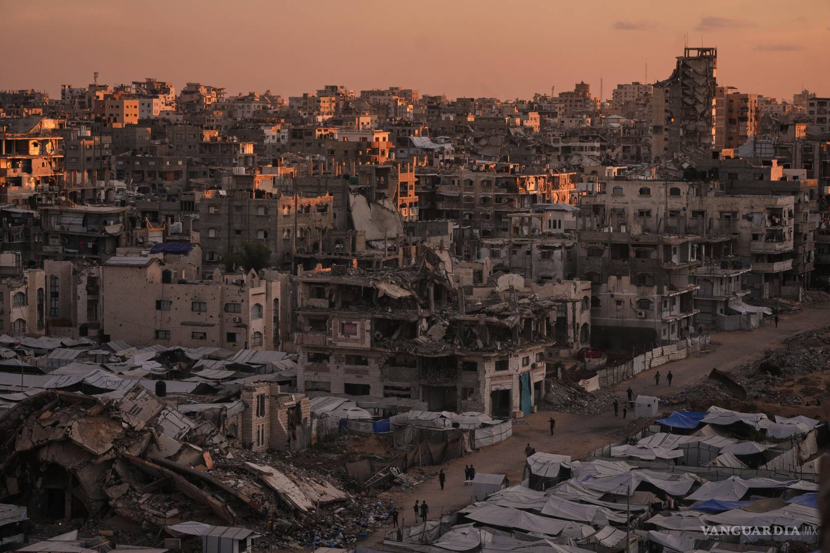 $!Vista aérea de una calle rodeada de edificios destruidos por ataques militares israelíes durante la guerra entre Israel y Hamas en la ciudad de Gaza.