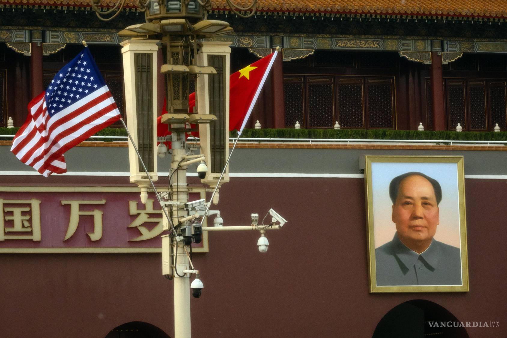 $!Las banderas de EU y China junto a un retrato del líder comunista chino y fundador de la República Popular China, Mao Zedong, en la Plaza de Tiananmén.