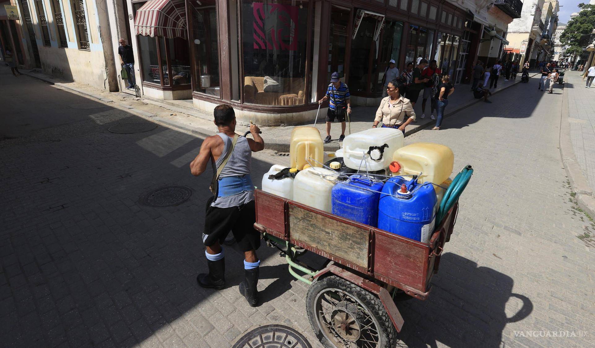 $!Una persona llevando tanques con agua, en La Habana, Cuba.