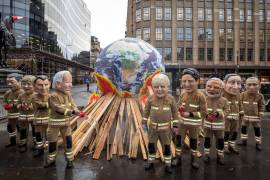 Activistas mientras posan como líderes mundiales disfrazados de bomberos este viernes durante el último día de la COP26 en Glasgow, Escocia. El nuevo borrador de acuerdo en la COP26 ha generado reacciones encontradas. EFE/Oxfam/Andy Aitchison