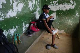 Yeferson Seijas se pone sus zapatos deportivos para un entrenamiento de béisbol en La Guaira, Venezuela; después de que los sismos dejaran a su familia sin hogar.