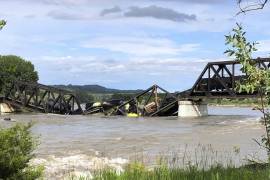 Varios vagones de un tren de carga están semisumergidos en el río Yellowstone tras el derrumbe de un puente cerca de Columbus, Montana.