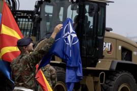 SKOPJE (North Macedonia), 03/07/2026.- A North Macedonia's soldier adjusts the NATO flag during the event of the promotion of new military equipment at Ilinden Barracks in Skopje, Republic of North Macedonia, 03 July 2026. As part of cooperation with the European Union and with support from the European Peace Facility, equipment worth more than 40 million euros has been procured in three packages; items from the first package and part of the second have already been delivered to the country. The equipment includes various assets—radars, thermal cameras, transport vehicles, simulators, a 3D radar system, and portable sensors—while the third package will provide equipment for logistics, communications, and infantry units. EFE/EPA/GEORGI LICOVSKI