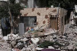 Una niña palestina mira por la ventana a los escombros de una casa derribada pro autoridades israelíes en el vecindario de Silwan, en Jerusalén Oriental, el 19 de mayo de 2026.