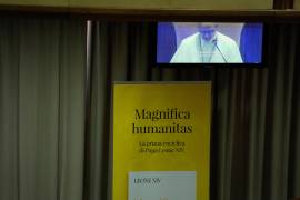 Pope Leo XIV, left, attends the presentation of his first encyclical, Magnifica humanitas: On Safeguarding the Human Person in the Time of Artificial Intelligence, at the Vatican, Monday, May 25, 2026. (AP Photo/Alessandra Tarantino)