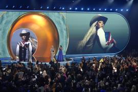 Beyonce accepts the award for album of the year for COWBOY CARTER during the 67th annual Grammy Awards on Sunday, Feb. 2, 2025, in Los Angeles. Blue Ivy Carter looks on from right.(AP Photo/Chris Pizzello)