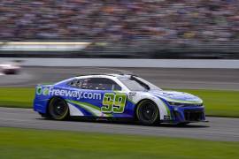 Daniel Suarez drives through a turn during a NASCAR Cup Series auto race at Indianapolis Motor Speedway in Indianapolis, Sunday, Aug. 13, 2023. (AP Photo/Michael Conroy)
