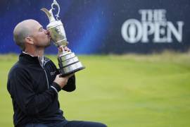 United States' Brian Harman poses for the media as he holds the Claret Jug trophy for winning the British Open Golf Championships at the Royal Liverpool Golf Club in Hoylake, England, Sunday, July 23, 2023. (AP Photo/Jon Super)