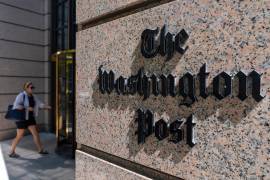 FILE - A person walks into the One Franklin Square Building, home of The Washington Post newspaper, June 21, 2024, in Washington. (AP Photo/Alex Brandon, File)