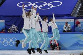 Patinadores del equipo del Comité Olímpico de Rusia celebran su victoria en la prueba de patinaje artístico por equipos de los Juegos Olímpicos de Invierno en Beijing. AP/David J. Phillip