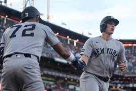 New York Yankees' Ben Rice, right, is congratulated by José Caballero (72) after scoring against the San Francisco Giants during the fifth inning of a baseball game in San Francisco, Wednesday, March 25, 2026. (AP Photo/Jeff Chiu)