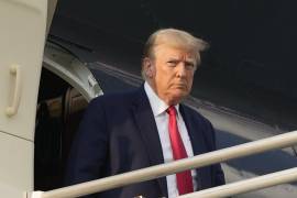 El expresidente Donald Trump se baja de su avión cuando llega al Aeropuerto Internacional Hartsfield-Jackson de Atlanta.