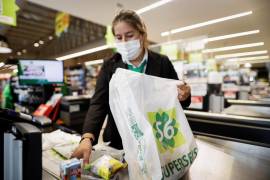 Una mujer guarda productos en una bolsa de polietileno reutilizable en un supermercado en Asunción, Paraguay.