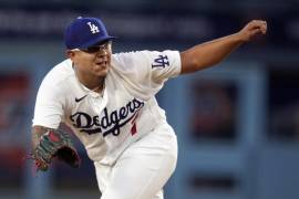 Los Angeles Dodgers starting pitcher Julio Urias follows through on a pitch to a Colorado Rockies batter during the first inning of a baseball game Tuesday, April 4, 2023, in Los Angeles. (AP Photo/Marcio Jose Sanchez)