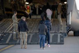 Un grupo de indocumentados sentados dentro de un avión militar camino a su deportación.