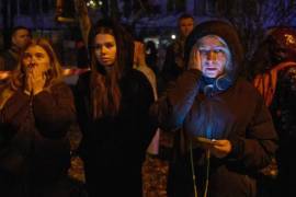 Los residentes locales observan su casa en llamas después del impacto de un dron en Kiev.