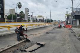 Trabajadores realizan labores de rehabilitación en la carpeta asfáltica del bulevar Independencia, donde las lluvias provocaron un hundimiento de aproximadamente 100 metros.