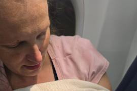 En esta imagen cortesía de Tina Fritz, Ashley Blair carga a su hija Brielle, quien nació el 24 de abril de 2026, a bordo de un vuelo de Delta Air Lines poco antes de aterrizar en Portland, Oregon.