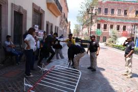 Miembros de la Coalición de Trabajadores de la Educación de Coahuila se congregan en la Plaza de Armas de Saltillo para protestar contra las barreras que rodean el edificio gubernamental.