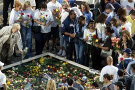 Familiares de las víctimas de los atentados contra el World Trade Center depositan flores en uno de los dos estanques que reproducen la huella de las dos torres del World Trade Center en la Zona Cero en Nueva York.