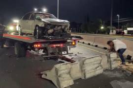 El Chevrolet Malibu fue remolcado luego de que terminó volcado sobre su costado derecho tras impactarse contra el muro de contención.