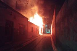 Bomberos trabajaron durante la madrugada para evitar que el incendio se propagara a viviendas cercanas en la calle Pino Suárez.