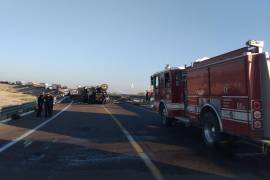 Vista del tráiler volcado y los polines de aluminio sobre la carretera, tras el accidente ocurrido esta mañana.