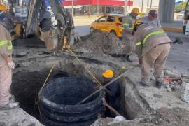 Trabajadores realizan maniobras en el área donde se presentó el hundimiento que obligó a intervenir la infraestructura sanitaria.