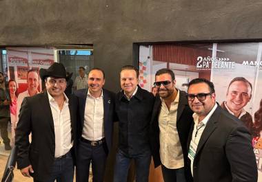 Manolo Jiménez Salinas saluda a Julión Álvarez en el Coliseo Centenario durante su informe.