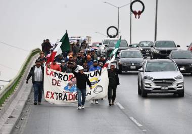 Manifestantes muestran carteles y documentos con sus demandas laborales acumuladas desde hace tres años.
