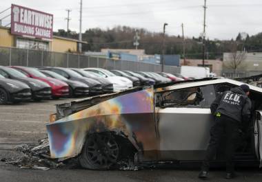 Un miembro del departamento de bomberos de Seattle inspecciona un Tesla Cybertruck en un estacionamiento de Tesla en Seattle. Los ataques a concesionarios de Testa están proliferando.