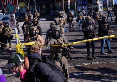 Federal immigration officers deploy pepper spray at protesters after a shooting Saturday, Jan. 24, 2026, in Minneapolis. (AP Photo/Abbie Parr)