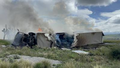 Bomberos de Arteaga trabajaron para sofocar el incendio del tráiler accidentado y evitar más percances.